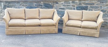 Classic Love Seat And Couch Covered In Light Brown Fabric