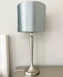 A Brushed Steel Lamp With Silver Tone Shade