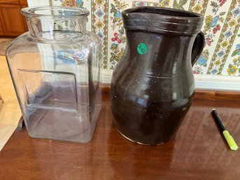 A BROWN STONEWARE JUG AND AN ANTIQUE GLASS CANDY CONTAINER