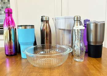 A Glass Mixing Bowl And Various Water And Coffee To Go Cups