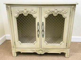 A French Provincial Painted Wood Commode With Grille Work Panels In Doors