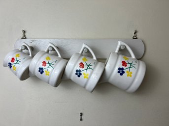 Set Of Four Vintage Measuring Cups On A Hanging Peg Rack