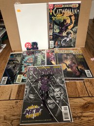 7 Catwoman Comic Books And 1 Cart