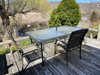 Patio Table And Three Charis.