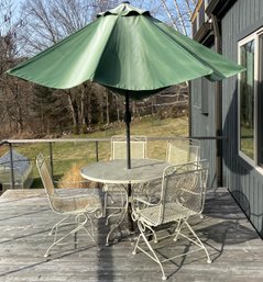 Wrought Iron Table, Four Chairs And An Umbrella