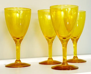 A Set Of 4 Amber Glass Cordials