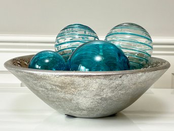 A Polished Alloy Serving Bowl And Hand Blown Glass Baubles