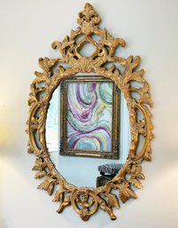 A Large And Ornately Framed Mirror