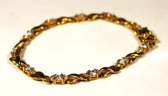 GOLD OVER STERLING SILVER BRACELET HAVING WHITE GEMSTONES