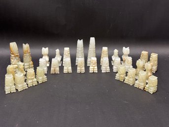 A Set Of Vintage Chess Pieces In Natural Stone