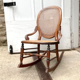 A Victorian Walnut Carved Cane Petite Rocker