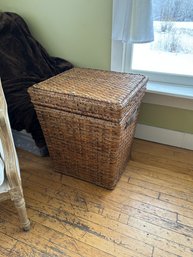 A WICKER HAMPER WITH CLEAN BEDDING