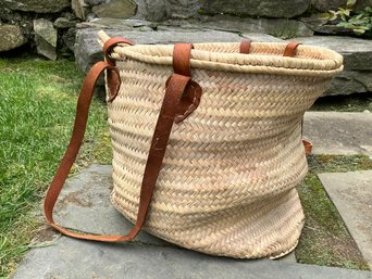 A Vintage Woven Beach Or Towel Bag With Leather Straps And Handles