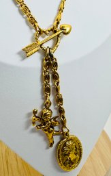 SIGNED 1928 GOLD TONE HEART & ARROW, CHERUB AND PORTRAIT DANGLE NECKLACE