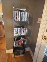 A WROUGHT IRON RACK WITH DVDS