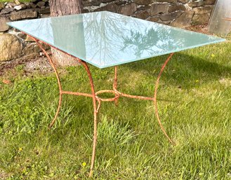 A Vintage Wrought Iron Dining Table With Modern Frosted Glass Top