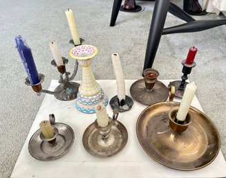 Eight Different Types Of Candle Holders One With Three Bronze Holders And Reaming One Bronze Holders.