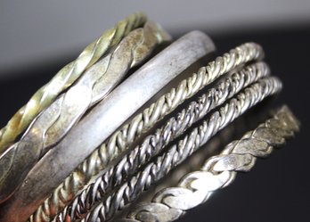 FINE LOT SEVEN STERLING SILVER AND SOLID SILVER MEXICAN BANGLE BRACELETS