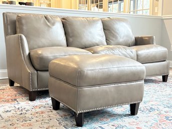 A Custom Leather Sofa With Nailhead Trim And Matching Ottoman By Bradington-Young
