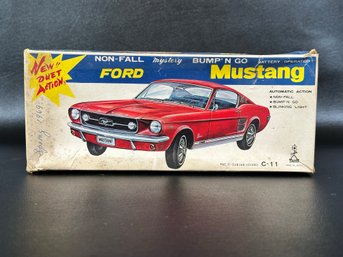 A Vintage Red Ford Mustang Bump'n'Go Car With Original Box