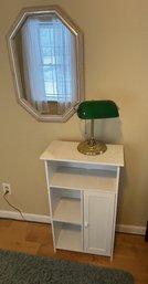 A WHITE CABINET, A BANKERS LAMP, AND A MIRROR