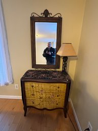 A PAINTED CHEST, MIRROR, LAMP, AND TABLE RUNNER