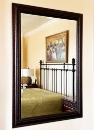 A Beveled Mirror In Wood Frame
