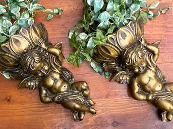 A Pair Of Gilt Cherub Form Wall Pockets