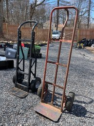 A Pair Of Hand Trucks With Pneumatic Tires
