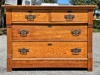 A Late 19th Century Paneled Oak Chest Of Drawers