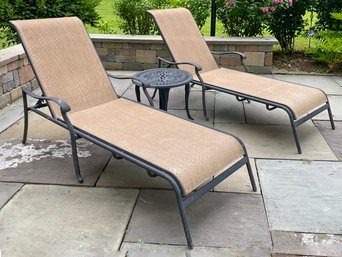 A Pair Of Cast Aluminum And Mesh Chaises And A Cocktail Table By Cast Classics