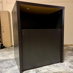 An Ebony Stained End Table With Slide Out Bottom Cabinet On Rollers