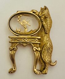 GOLD TONE CAT GAZING AT FISHBOWL ON TABLE BROOCH