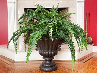 A Faux Fern In Acrylic Urn