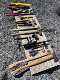 A Collection Of Axes, Sledges, Tree Trimming Tools And An Electric Chain Saw