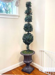 A Large Faux Ivy Topiary In Cast Acrylic Urn