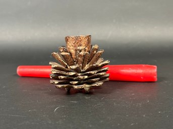 A Rustic Metal Pinecone Taper Holder