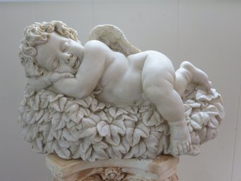 Sculpture Of A Sweet Dreams Cherub Asleep On Top Of A Bush