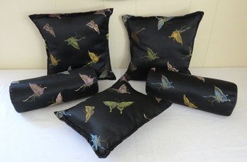 A Group Of Black Satiny Fabric Butterfly Pillows