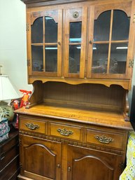 Two Piece Hutch With Glass Doors On Top With Drawers And Cabinet On Bottom.