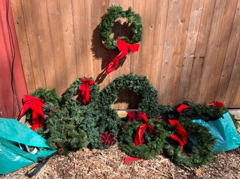 A Large Collection Of Christmas Wreaths And Accessories