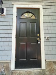 A Vinyl Clad Exterior Door With Half Round Lite