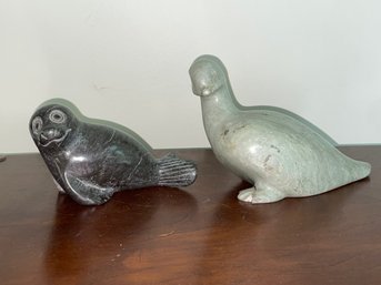 A CARVED STONE SEAL AND A CARVED STONE BIRD