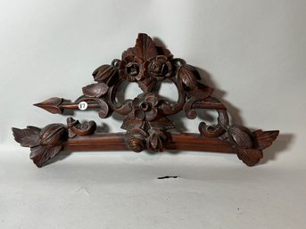 A CARVED WALNUT CREST