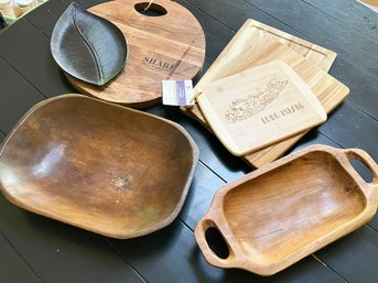 An Assortment Of Wood Cutting Boards And Serving Bowls