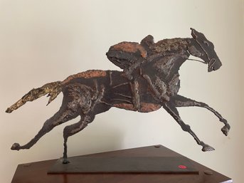 A STEEL CONTEMPORARY ART SCULPTURE OF A JOCKEY ON A HORSE