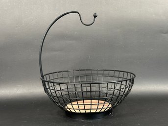 A Contemporary Fruit Bowl In Black Wire With A Banana Hook