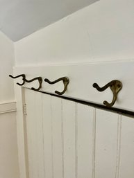 A Group Of Eight Brass Wall Hooks