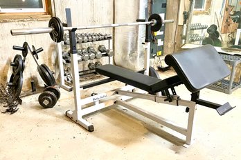 A Weight Bench, Racks, And Weights By Body Solid