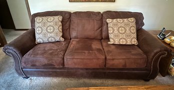 Leather & Suede 3 Seater Sofa With Decorative Upholstery Tacks Along Front Of Curled Armrests & 2 Pillows. LR